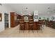 Spacious kitchen with custom cabinetry, granite countertops, and a breakfast bar with seating at 13719 Seminole Trl, Wimauma, FL 33598