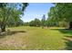 Sprawling land perfect for recreation, boasting ample space and natural beauty under a clear blue sky at 13719 Seminole Trl, Wimauma, FL 33598