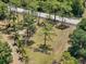 Aerial view of a lovely fenced lot with mature pines and palm trees on a quiet street at 13719 Seminole Trl, Wimauma, FL 33598