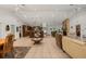 Bright and open living room featuring tile flooring, a cozy fireplace, and seamless flow into the kitchen at 13719 Seminole Trl, Wimauma, FL 33598