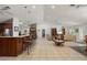 Open-concept living area with tile floors, a large island, bar seating, and natural light at 13719 Seminole Trl, Wimauma, FL 33598