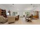 Spacious living and dining area with tile flooring, natural light, and comfortable seating arrangements at 13719 Seminole Trl, Wimauma, FL 33598