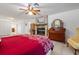 Well-lit primary bedroom featuring a fireplace, wood furnishings, and tiled floors at 13719 Seminole Trl, Wimauma, FL 33598