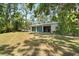 A functional outbuilding with multiple garage doors, providing ample space for storage and projects at 13719 Seminole Trl, Wimauma, FL 33598