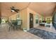 Spacious patio with fan and tile floor, perfect for relaxing and outdoor dining at 13719 Seminole Trl, Wimauma, FL 33598