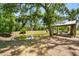 Secluded pond with shade trees offers a peaceful outdoor retreat on the property at 13719 Seminole Trl, Wimauma, FL 33598