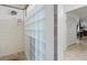 Shower featuring glass block wall, tile surround, and view to bedroom at 13719 Seminole Trl, Wimauma, FL 33598