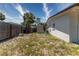 Wide view of the backyard featuring a storage shed, lush vegetation, and a sturdy privacy fence at 138 Pearl Ave, Sarasota, FL 34243