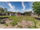 Spacious backyard featuring a patio with red chairs and two storage sheds, great for outdoor entertaining at 138 Pearl Ave, Sarasota, FL 34243