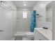 The remodeled bathroom features tile surround, open storage shelves and a glass block window at 138 Pearl Ave, Sarasota, FL 34243