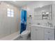 Bright bathroom featuring a modern shower, sleek vanity, and white marble-like tile at 138 Pearl Ave, Sarasota, FL 34243