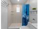 This bathroom features tile surround, open storage shelves and a glass block window at 138 Pearl Ave, Sarasota, FL 34243