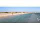 Breathtaking beachfront view, displaying the calm ocean, white sandy beach, and distant cityscape at 138 Pearl Ave, Sarasota, FL 34243