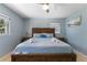 This is a cozy bedroom featuring a queen bed and a serene blue color scheme, perfect for relaxation at 138 Pearl Ave, Sarasota, FL 34243