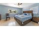 Bright bedroom features terrazzo floors, a ceiling fan, and a large window for natural light at 138 Pearl Ave, Sarasota, FL 34243