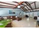 Bright living room featuring a large leather sectional, exposed beams, and expansive windows, creating a welcoming atmosphere at 138 Pearl Ave, Sarasota, FL 34243