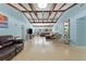 Spacious living room with exposed beam ceiling, terrazzo floors, and lots of natural light, perfect for entertaining at 138 Pearl Ave, Sarasota, FL 34243