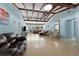 Spacious living room with exposed beam ceiling, terrazzo floors, and lots of natural light, perfect for entertaining at 138 Pearl Ave, Sarasota, FL 34243