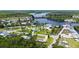 Aerial view of neighborhood with home on grassy corner lot near waterway at 156 Myakka Rd, Venice, FL 34293