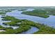 Expansive aerial view of winding river tributaries surrounded by lush greenery and distant buildings at 156 Myakka Rd, Venice, FL 34293