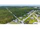 Aerial view of a charming single-story home surrounded by lush greenery and a quiet residential neighborhood at 156 Myakka Rd, Venice, FL 34293