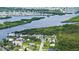 Stunning aerial view of the waterfront neighborhood with lush greenery surrounding the homes at 156 Myakka Rd, Venice, FL 34293
