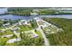 Aerial view of neighborhood with home on grassy corner lot near waterway at 156 Myakka Rd, Venice, FL 34293