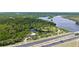 High aerial view overlooking serene bodies of water adjacent to a roadway and a wooded area at 156 Myakka Rd, Venice, FL 34293