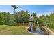A canal view features lush foliage and a covered dock perfect for relaxing and nature viewing at 156 Myakka Rd, Venice, FL 34293