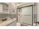 Modern bathroom featuring granite countertops, marbled tiling, and glass-enclosed shower at 156 Myakka Rd, Venice, FL 34293