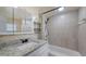 Bright bathroom featuring granite countertops and decorative tiling around the shower and mirror at 156 Myakka Rd, Venice, FL 34293