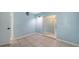 Light blue bedroom with tile flooring and view of adjacent bath and bedroom at 156 Myakka Rd, Venice, FL 34293