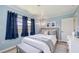 Cozy bedroom with blue accents, natural light, and comfortable furnishings for a relaxing retreat at 156 Myakka Rd, Venice, FL 34293