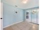 Light blue bedroom with tile flooring and view of adjacent living area at 156 Myakka Rd, Venice, FL 34293