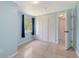 A bright bedroom features tile floors, a window with curtains and a double door closet at 156 Myakka Rd, Venice, FL 34293