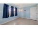 Light blue bedroom with tile flooring, an adjacent window with curtains, and neutral trim at 156 Myakka Rd, Venice, FL 34293
