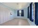 Comfortable bedroom with tile flooring, window, closet, and blue walls at 156 Myakka Rd, Venice, FL 34293