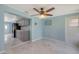 Open concept dining area with marble tile floors, ceiling fan, and bright blue walls at 156 Myakka Rd, Venice, FL 34293