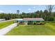Charming single-story home boasts a colorful exterior, well-manicured lawn, and an attached carport at 156 Myakka Rd, Venice, FL 34293