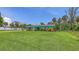 Exterior view of home with colorful facade and large grassy front yard at 156 Myakka Rd, Venice, FL 34293