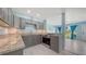 Updated kitchen with gray cabinets, granite countertops, stainless steel appliances, and marble tile flooring at 156 Myakka Rd, Venice, FL 34293