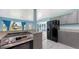 Kitchen with granite counters, grey cabinetry, stainless steel appliances, and an adjoining breakfast nook at 156 Myakka Rd, Venice, FL 34293