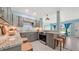Modern kitchen featuring gray cabinetry, granite countertops, stainless steel appliances, and an open breakfast bar at 156 Myakka Rd, Venice, FL 34293