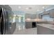 Updated kitchen with granite countertops, gray cabinets, stainless steel appliances, and marble floors at 156 Myakka Rd, Venice, FL 34293