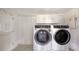 Laundry room features updated washer and dryer units with built-in storage and access to exterior at 156 Myakka Rd, Venice, FL 34293