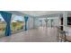 Inviting living room with tile floors and ample natural light from the large windows at 156 Myakka Rd, Venice, FL 34293