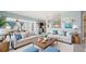 Spacious open-concept living room features plush seating, modern decor, and seamless flow into dining and kitchen areas at 156 Myakka Rd, Venice, FL 34293