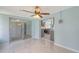 Bright living room featuring marble floors, a ceiling fan, and an open view of the kitchen at 156 Myakka Rd, Venice, FL 34293