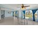 Open living space with connecting sunroom, kitchen, and ceramic tile flooring at 156 Myakka Rd, Venice, FL 34293