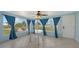 Bright sun room with floor-to-ceiling windows, tiled floor, and modern table at 156 Myakka Rd, Venice, FL 34293